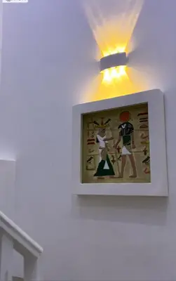 a light on a wall with a picture on it at Princess resort Hurghada in Hurghada