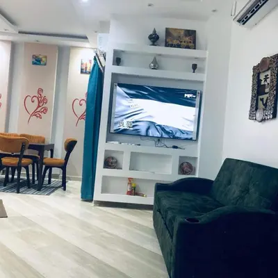a living room with a couch and a flat screen tv at Princess resort Hurghada in Hurghada