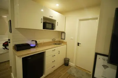 a small kitchen with a sink and a microwave at modern studio- 7 min from aswan station in Aswan