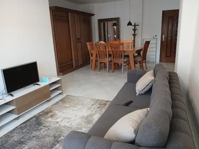 a living room with a couch and a television at Flat 10 minutes from the airport in Hurghada