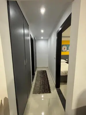 a hallway with a room with a bed and a rug at Fanadir Bay Resort Canary Apartman in Hurghada
