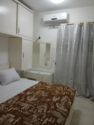 a bedroom with a bed and a window with a curtain at شقه مميزه في عرابيا الغردقه امام فندق بيروت in Hurghada