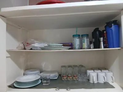 a pantry with plates and dishes on a shelf at شقه مميزه في عرابيا الغردقه امام فندق بيروت in Hurghada