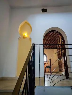 a staircase in a building with a light on the wall at FairHaven Apartments in Luxor