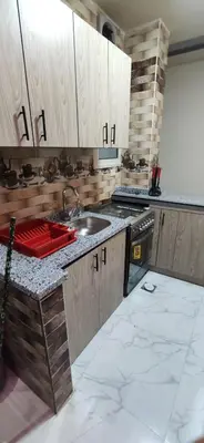 a kitchen with wooden cabinets and a sink at الغردقة شارع مترو in Hurghada
