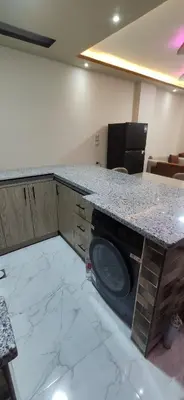 a kitchen with a counter with a washing machine at الغردقة شارع مترو in Hurghada