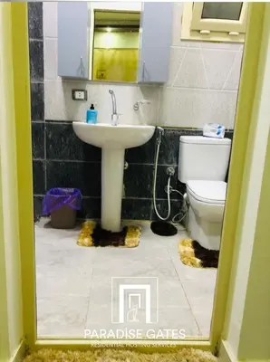 a bathroom with a sink and a toilet at Paradise Gates Hurghada in Hurghada
