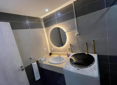 a bathroom with a sink and a washing machine at Fanadir Bay Premier all inclusive resort in Hurghada