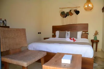 a bedroom with a bed and a table and a chair at Fanadir Bay Premier all inclusive resort in Hurghada