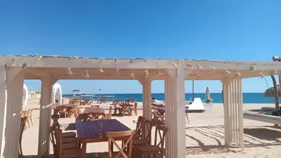 a restaurant on the beach with tables and chairs at Princess Beachfront Resort Hurghada in Hurghada