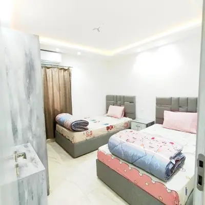 a bedroom with two beds and a tub in it at Princess Beachfront Resort Hurghada in Hurghada