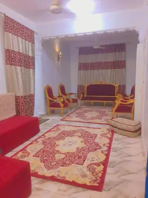 a living room with a couch and a rug at the golden house in Luxor