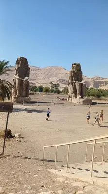 a group of children playing a game in the desert at the golden house in Luxor