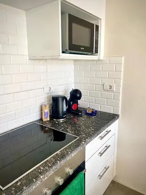 a kitchen with a counter top with a microwave at Gouna Retreat with Private Pool in Bali in Hurghada