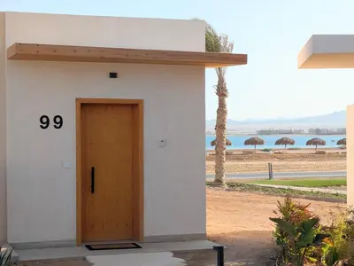 a small building with a door with the number at Beachfront Somabay Cabana Steps From Sea & Pool in Hurghada