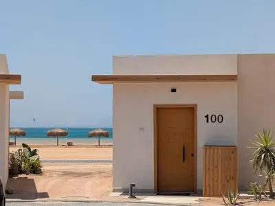 a small building with a door on the beach at Beachfront Somabay Cabana Steps From Sea & Pool in Hurghada