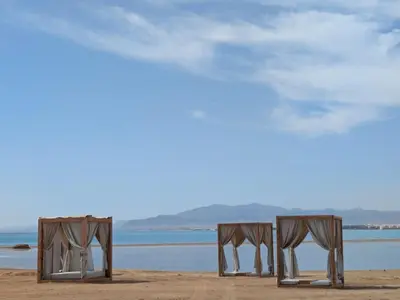 two chairs on a beach with the ocean in the background at Beachfront Somabay Cabana Steps From Sea & Pool in Hurghada