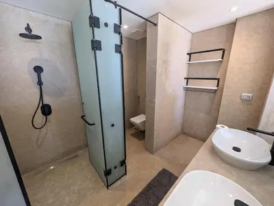 a bathroom with a shower and a toilet and a sink at Beachfront Somabay Cabana Steps From Sea & Pool in Hurghada