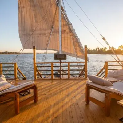 a wooden deck with two beds on a sail boat at ايجبت تورز in Luxor