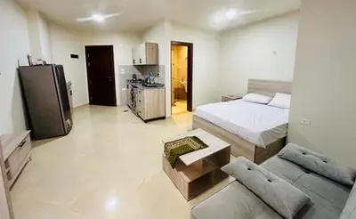 a bedroom with a bed and a couch in it at Zuni in Hurghada