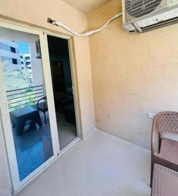 a room with a sliding glass door to a balcony at Zuni in Hurghada