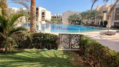 a swimming pool with a gate in a resort at Mangroovy Gouna Beach and pool in Hurghada