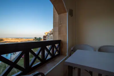 a balcony with a table and chairs and a view at Al Saraya Sahl Hasheesh by Peaks One Bedroom Apartment With Pool View B405&A410 in Hurghada