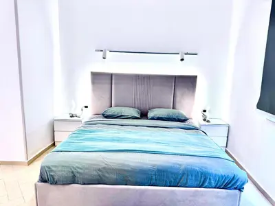 a bedroom with a large bed with blue sheets at Al Saraya Sahl Hasheesh by Peaks One Bedroom Apartment With Pool View B405&A410 in Hurghada