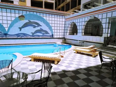 a swimming pool with a mural of dolphins on the wall at Sheraton Plaza Hurghada in Hurghada