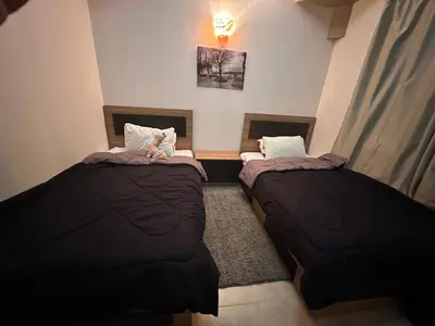 two beds sitting in a room at Luxury cozy apartment in Hurghada