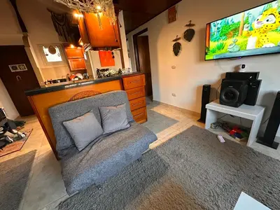 a living room with a couch and a flat screen tv at Luxury cozy apartment in Hurghada