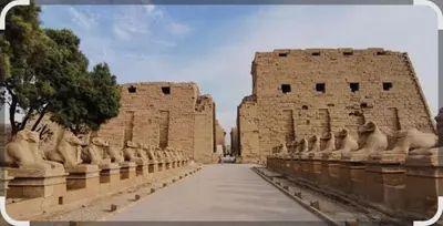 a building with statues in front of it at Elbess For Tourism in Al Karnak