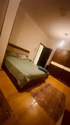 a bedroom with a bed and a rug at Chill & Cozy Stay in Hurghada