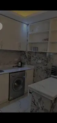 a kitchen with a sink and a washing machine at Hurghada Hub in Hurghada