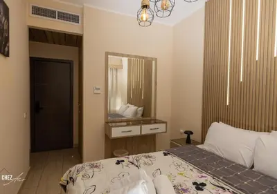 a bedroom with a bed and a mirror at Luxury Rooftop Penthouse Sea View & Pools in Hurghada