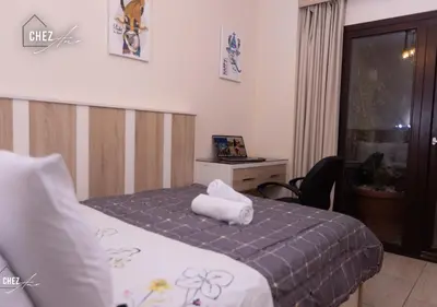 a hotel room with a bed with a towel on it at Luxury Rooftop Penthouse Sea View & Pools in Hurghada