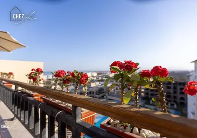 a row of red roses on a balcony at Luxury Rooftop Penthouse Sea View & Pools in Hurghada