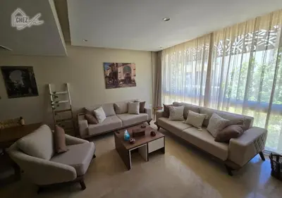 a living room with two couches and a coffee table at Mangroovy Retreat Smart home in Hurghada