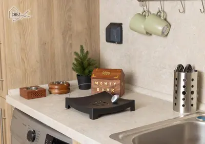 a kitchen counter with a sink with a money box on it at Mangroovy Retreat Smart home in Hurghada