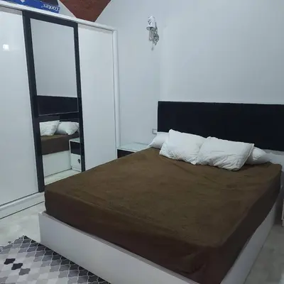 a bedroom with a large bed with a brown blanket at Veranda SH in Hurghada