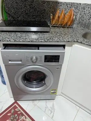 a washing machine under a counter in a kitchen at جوليانا الغردقة juliana beach D410 in Hurghada