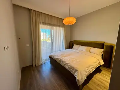a bedroom with a bed with a large window at Gouna Ancient Hill 3 BDR Nanny Privat Pool Lagoon View in El Gouna