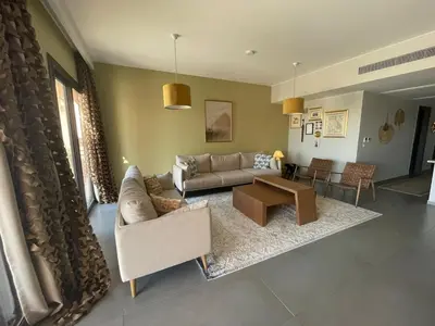 a living room with a couch and a table at Gouna Ancient Hill 3 BDR Nanny Privat Pool Lagoon View in El Gouna