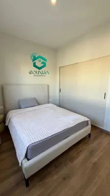 a bedroom with a bed with a white comforter at Shedwan Twinhouse 3 bedrooms in Hurghada