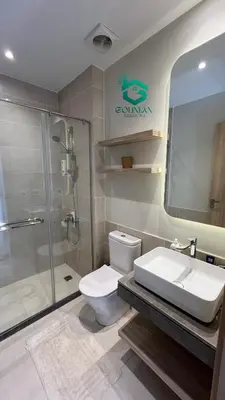 a bathroom with a toilet and a shower and a sink at Shedwan Twinhouse 3 bedrooms in Hurghada