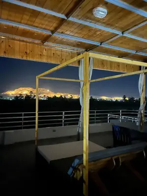 a room with a balcony with a view of a mountain at Nile Spirit Apt 2 in Jazīrat al ‘Awwāmīyah