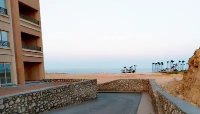 a building on the beach next to a building at Bay view in Hurghada