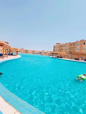 a person swimming in a large swimming pool at Bay view in Hurghada
