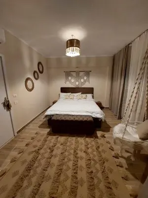 a bedroom with a large bed and a chandelier at Bay view in Hurghada