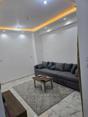a living room with a couch and a coffee table at Apartment almina3 in Hurghada